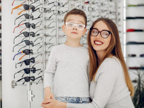 Mother with cute son. Family buy glasses